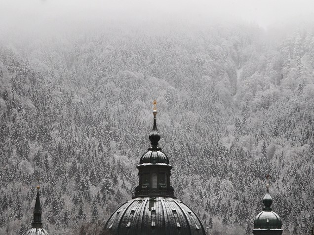 Torre da abadia de Ettal fotografada à frente da paisagem coberta por neve, em Ettal, sul da Alemanha