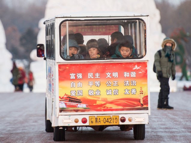Crianças montam em um ônibus de miniatura durante o Festival Internacional de Gelo e Neve de Harbin, na província de Heilongjiang, na China - 05/01/2015