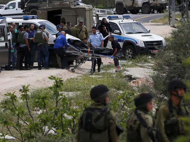 Corpo de palestino que esfaqueou dois soldados israelenses é retirado do local do ataque, em Maale Levona, Israel. Um dos soldados foi atingido no pescoço e levado ao hospital em estado crítico - 08/04/2015