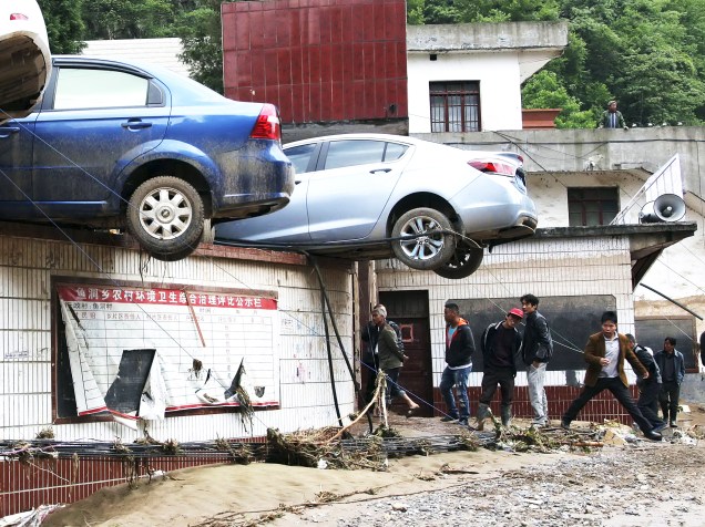 Moradores observam os estragos causados por inundação em Zhenxiong, no sudoeste da China; duas pessoas estão desaparecidas - 11/05/2015