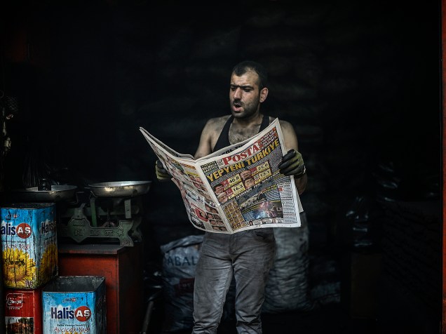 Homem lê um jornal com notícias das eleições parlamentares em Diyarbakir, na Turquia. O partido governista, de raízes islâmicas, perdeu a maioria absoluta do parlamento pela primeira vez desde a conquista do poder há 13 anos - 08/06/2015