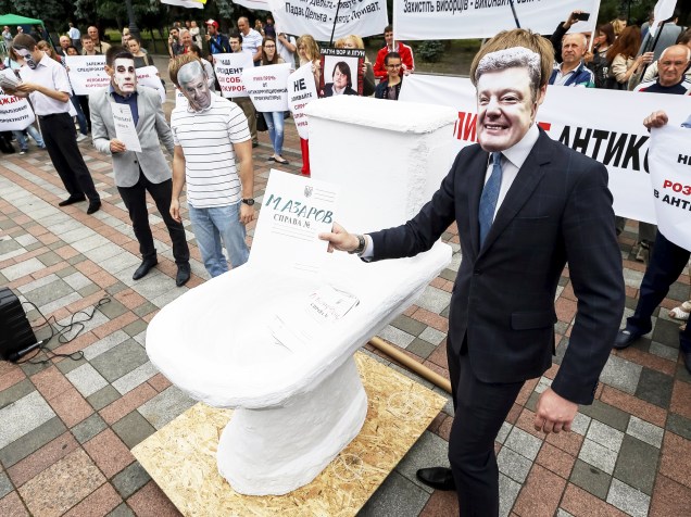 Ativista com máscara do presidente ucraniano Petro Poroshenko, protesta contra a corrupção em frente ao Parlamento de Kiev, na Ucrânia - 17/06/2015