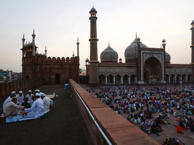 Muçulmanos comem seu Iftar (quebra do jejum) durante o mês sagrado do Ramadã na Jama Masjid (Mesquita grande) nos bairros antigos de Nova Délhi, Índia - 22/06/2015
