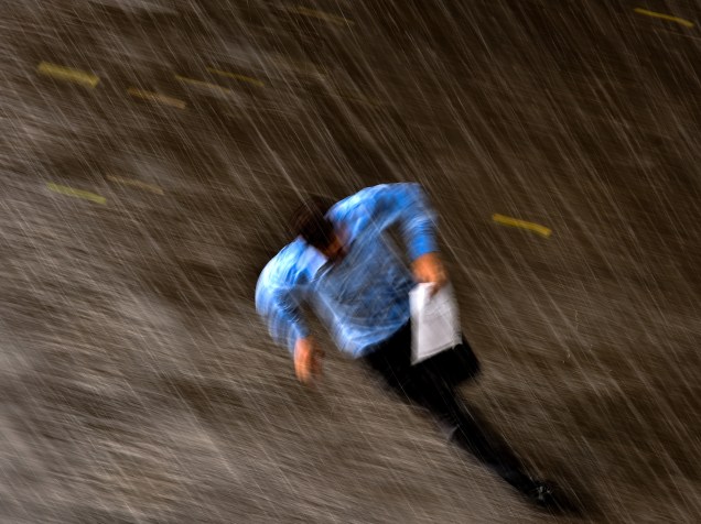 Homem corre debaixo da chuva pelas ruas do centro de Moscou, Rússia - 10/07/2015