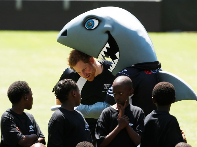 Durante viagem beneficente, o príncipe Harry foi abraçado pela mascote de um time de rúgbi numa sessão de treinamento em Durban, África do Sul