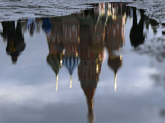 Catedral é refletida em poça de àgua na Praça Vermelha, em Moscou