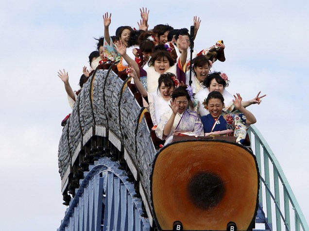 Mulheres japonesas vestidas com quimonos andam de montanha-russa durante a celebração do Dia da Maioridade, em um parque de diversões em Tóquio, no Japão