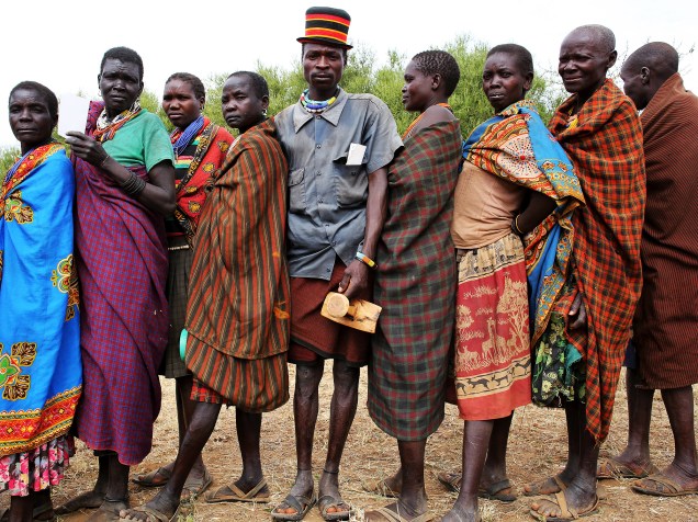  Membros da tribo Karamojong aguardam para votar em uma aldeia perto da cidade de Kaabong, no Uganda, durante as eleições do país