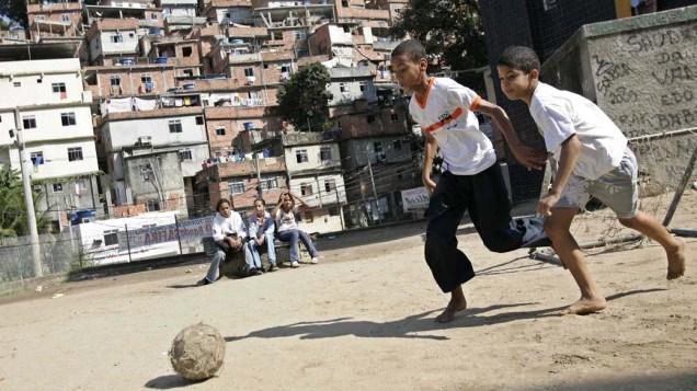 Meninos jogam futebol na favela da Rocinha no Rio de Janeiro