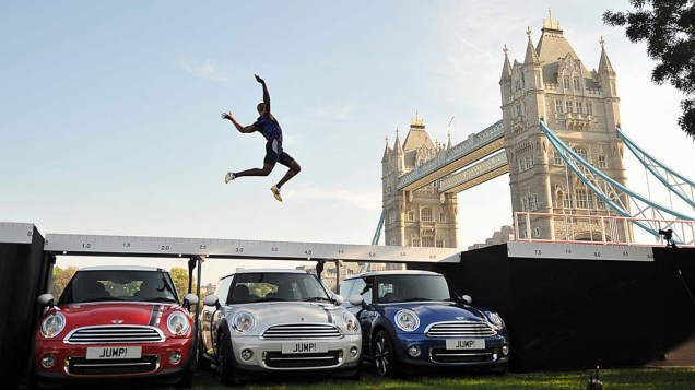O atleta olímpico J. J. Jegede salta sobre três carros em Londres