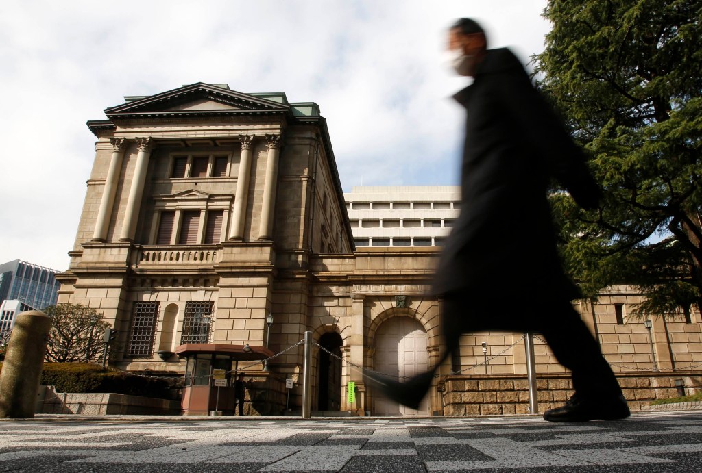 A man walks past in front of the Bank of Japan in Tokyo February 14, 2013. Bank of Japan Governor Masaaki Shirakawa said on Thursday that the central bank's monetary policy is not directly targeting currency moves. "The BOJ is conducting monetary policy to achieve stability in Japan's economy. It will continue to do so and I will explain this to the G20 nations," Shirakawa told a news conference ahead of a gathering of G20 finance leaders in Moscow over the weekend. Picture is taken in slow shutter REUTERS/Yuya Shino (JAPAN - Tags: BUSINESS)