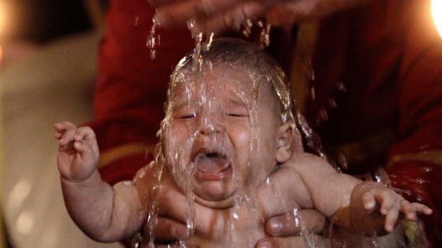 Bebê durante cerimônia de batismo em massa em Tbilisi, Geórgia