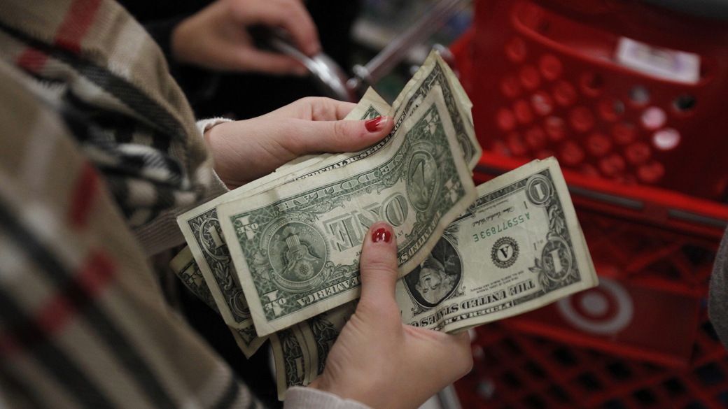 Consumidora conta o dinheiro enquanto espera na fila do caixa da loja Target durante a Black Friday em Connecticut