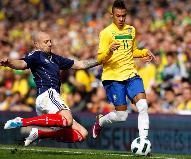 Neymar disputa a bola com Alan Hunton, durante amistoso entre as seleções do Brasil e Escócia, em Londres - 27/03/2011