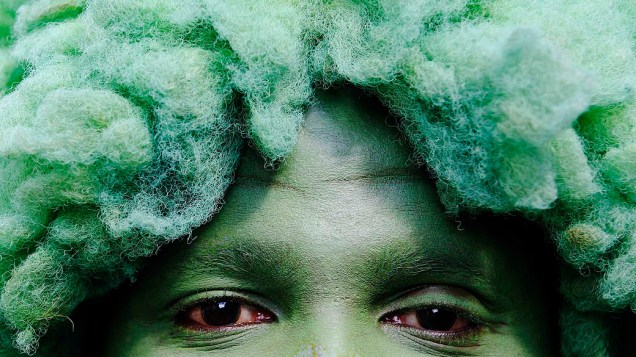 Pintado de verde, homem participa do tradicional Carnaval de Notting Hill nas ruas do bairro londrino. O evento inspirado em festas do Caribe é o maior carnaval de rua da Europa