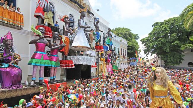 Foliões brincam entre bonecos gigantes e bandas no largo em frente a prefeitura da cidade de Olinda