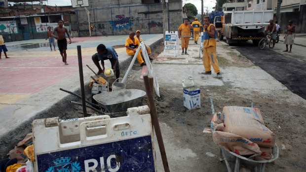 Funcionários da Prefeitura do Rio trabalham na quadra que deve ser visitada por Obama na Cidade de Deus: moradores se envolveram no embelezamento da favela