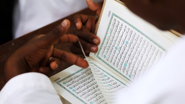 Estudante lê o Corão durante aula em escola islâmica de Madrasa, Zanzibar