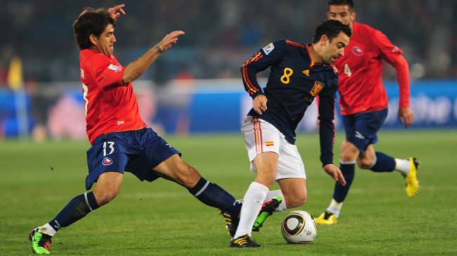 O chileno Marco Estrada tenta tirar a bola do espanhol Xavi