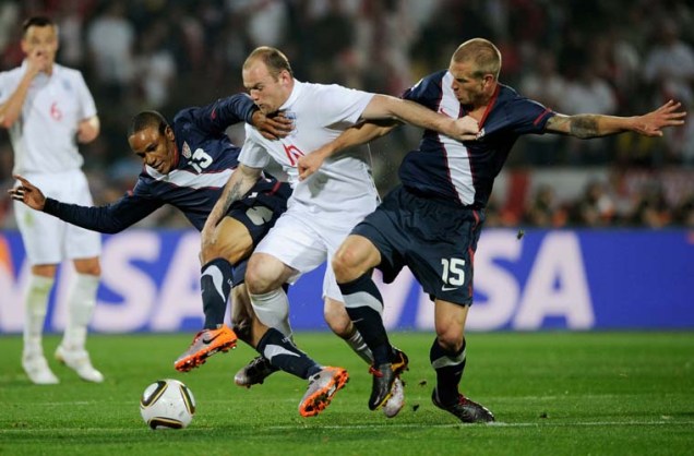 A estrela do time inglês, Wayne Rooney, disputa lance com os americanos Ricardo Clark (esquerda) e Jay Demerit.