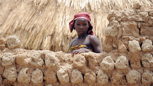 Criança nigeriana aguarda que oficiais da saúde avaliem o solo contaminado da região de Anka