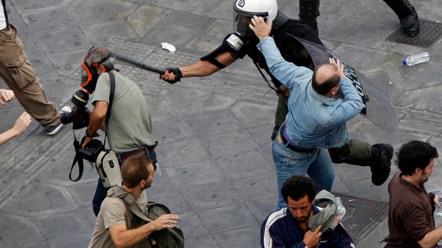 Policial agride membro da imprensa durante protesto em Atenas, Grecia