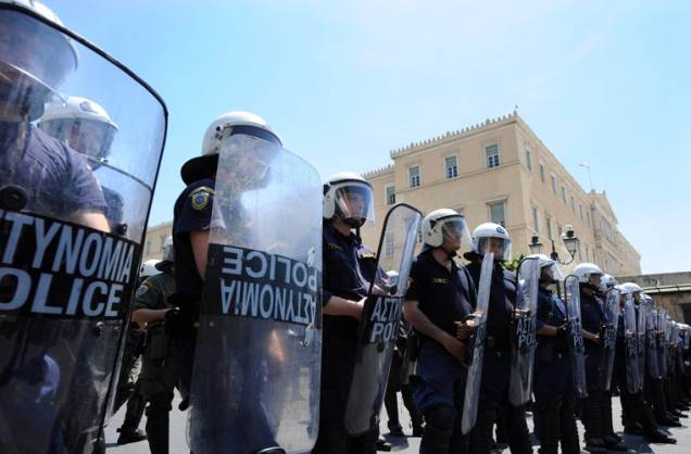 Polícia guarda a entrada do Parlamento grego, que votará o pacote de ajuda financeira de 146 bilhões de dólares do Fundo Monetário Internacional (FMI). A população pretende manifestar a sua opinião na quarta-feira, quando estão previstos greve geral e um grande protesto nas ruas de Atenas.