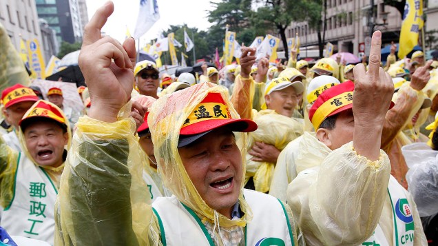 Trabalhadores de Taiwan durante protesto do Dia Internacional do Trabalho. Mais de 10 mil trabalhadores foram às ruas para protestar contra um plano de reforma do governo que irá cortar os pagamentos de pensão para aliviar agravamento dos problemas fiscais do país