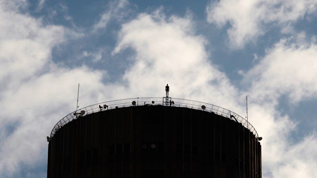 Figura de um homem feito de ferro e fibra de vidro pelo escultor britânico Antony Gormley, vista em telhado de um prédio no centro do Rio de Janeiro