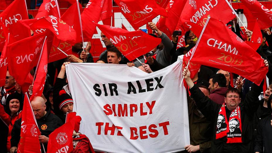 Torcedores estendem bandeiras em homenagem a Alex Ferguson, que assume o comando para o seu último jogo em casa antes de se aposentar, no estádio Old Trafford, em Manchester