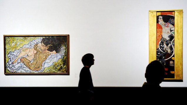 Visitantes observam as obras "Salomé" (direita) e "The Embrace" (O Abraço) (esquerda) do artista austríaco Gustav Klimt no Palácio Belvedere em Viena, Áustria