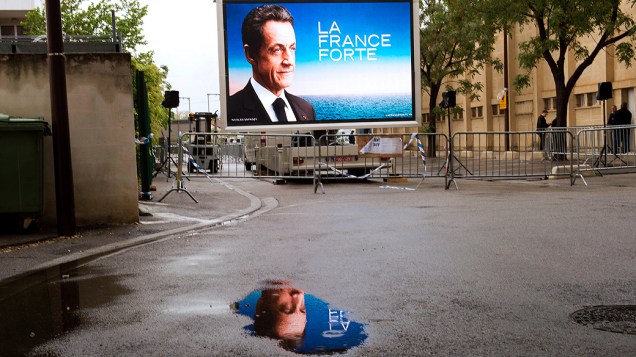 Tela gigante com um dos cartazes de apoio à campanha de Sarkozy durante encontro em Avignon, França