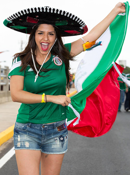 Torcedora do México segura bandeira do país antes do jogo contra o Brasil no Castelão, em Fortaleza