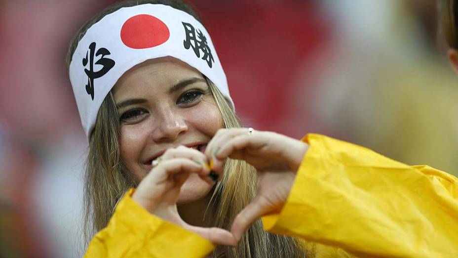 Torcedora do Japão faz coração com as mãos antes d jogo contra a Costa do Marfim na Arena Pernambuco, em Recife