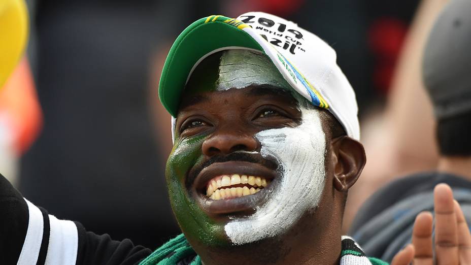 Torcedor da Nigéria pinta o rosto com as cores do país durante a estreia da seleção na Copa, em Curitiba