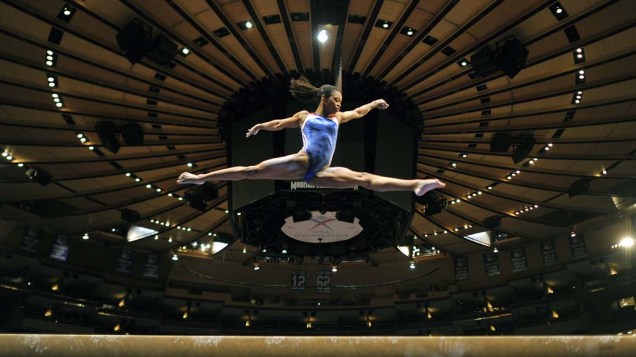A americana Gabby Douglas em aparelho de ginástica olímpica durante treino para a Copa Americana no "Madison Square Garden" em Nova York