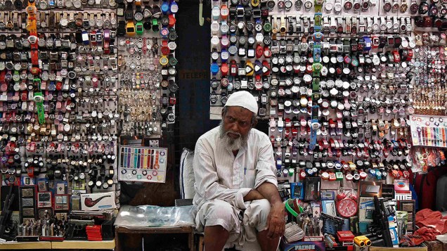Vendedor espera por clientes em uma venda na estrada de Calcutá, na Índia