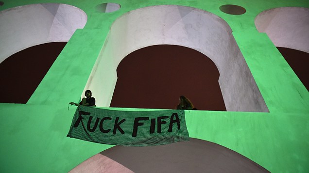 Manifestantes protesta contra a Fifa estendendo faixa nos Arcos da Lapa, no Rio de Janeiro