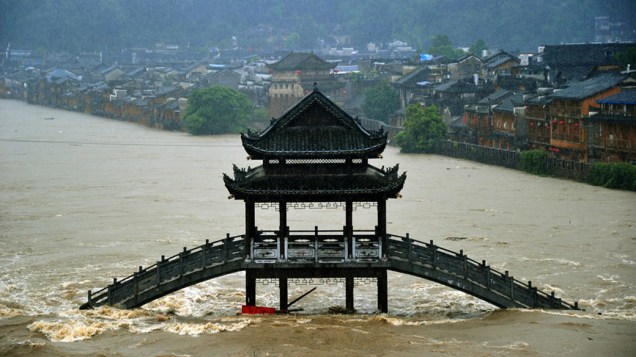 Pontes e edifícios ficaram submersos na cidade de Fenghuang em decorrência das chuvas torrenciais que atingiram a província de Hunan, no centro da China