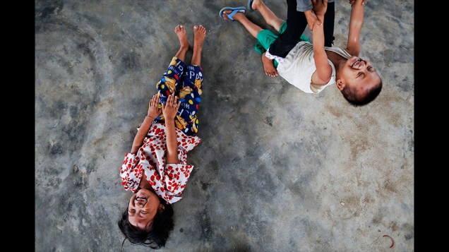 Crianças brincam em um acampamento para pessoas deslocadas internamente nos subúrbios de Myitkyina, a capital do Estado de Kachin, em Mianmar. Milhares de pessoas fugiram em função dos combates que eclodiram entre as tropas do governo de Mianmar e do Exército da Independência Kachin (KIA), após rompimento de um cessar-fogo, em 2011