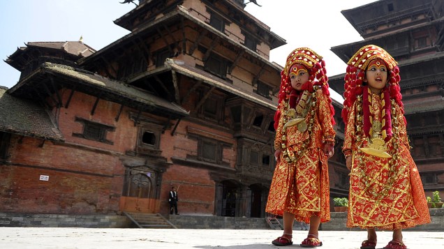 Meninas nepalesas vestidas com a roupa de Kumari, a deusa da vida, posam durante rituais do Kumari Puja na Praça Durbar, em Katmandu