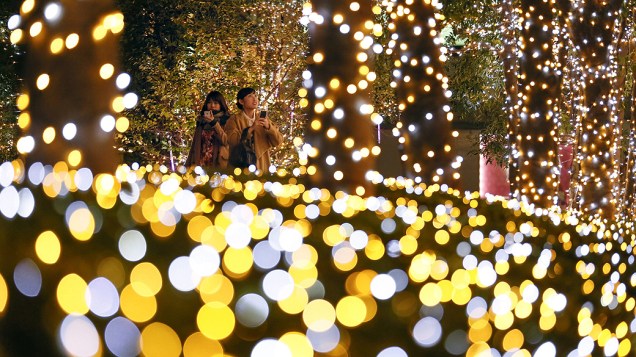 Mulheres observam a iluminação de Natal no distrito financeiro de Shinjuku, em Tóquio