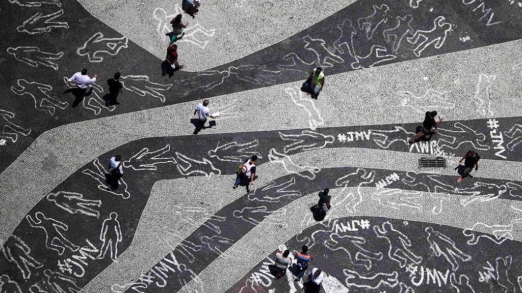 Contornos de giz representando corpos de pessoas mortas foram desenhados durante um protesto na praça da Carioca no centro do Rio de Janeiro representando as 4000 vítimas de violência que morreram no estado, em 2012