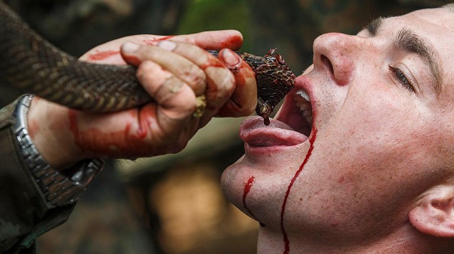 Um fuzileiro naval dos EUA bebe sangue de uma cobra durante um exercício de sobrevivência na selva, em uma base militar na província de Chanthaburi, na Tailândia