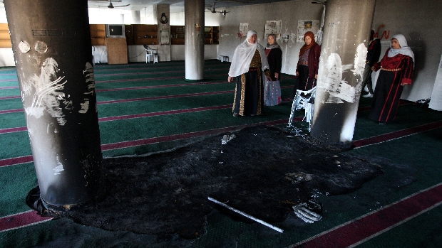 Palestinas observam parte da mesquita em Burka incendiada