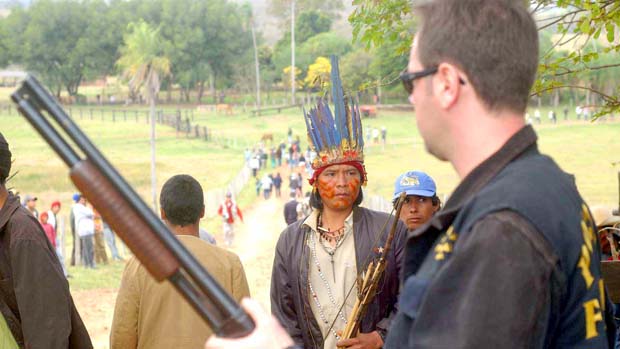 Agente da PF observa índios na fazenda Buriti, em Sidrolândia (MS)