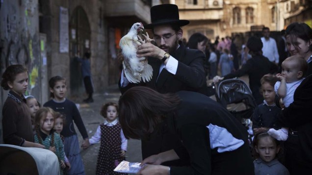 Em Jerusalém, judeu ultra-ortodoxo realiza o ritual Kaparot, no qual “transfere” os pecados para uma galinha
