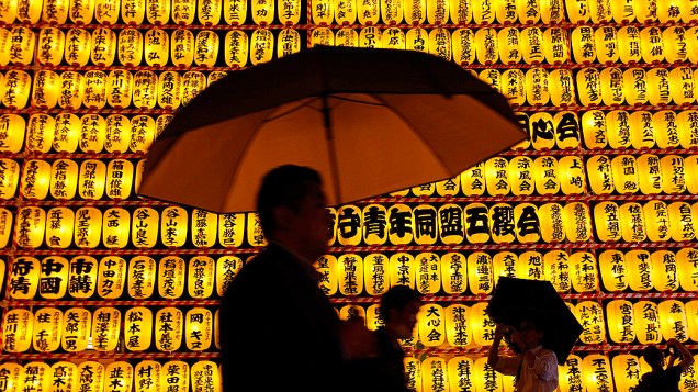 Visitantes observam as cerca de 3 mil lanternas de papel durante o festival Mitama, no santuário de Yasukuni, em Tóquio, no Japão