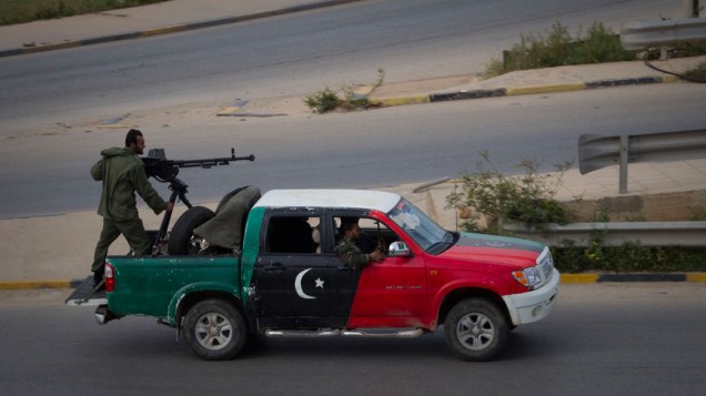 Rebeldes dirigem em região próxima ao local da queda do caça do governo de Muamar Kadafi, em Bengasi