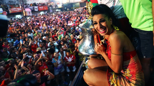 Musa da Mocidade Alegre, Aline Oliveira, comemora o título da escola ao lado do troféu do Carnaval de São Paulo